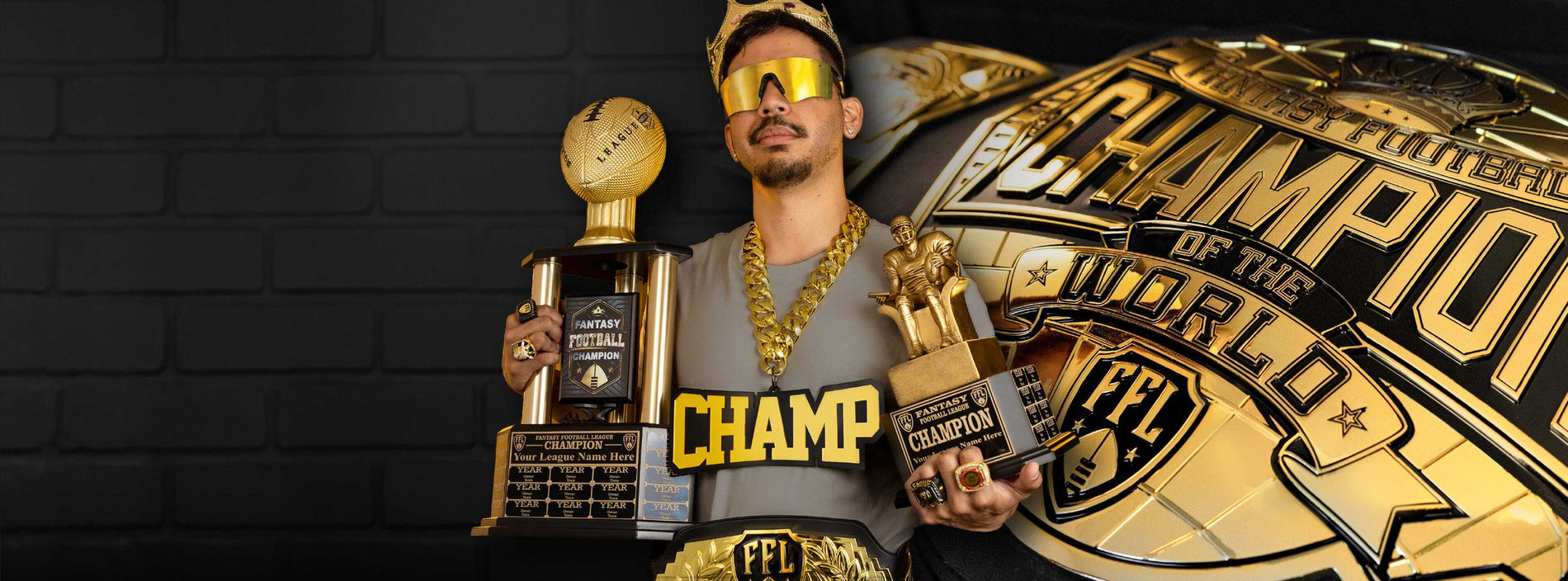 A man wearing a gold cap, gold chain, and gold-framed sunglasses holds two gold-colored trophies in front of a dark gray brick wall. A large golden 'Championship of the World' graphic overlay is on the right side of the image.
